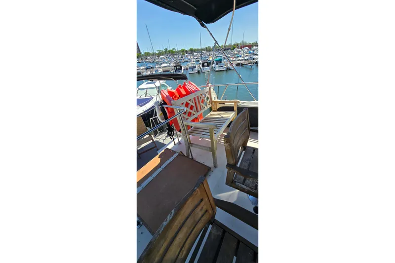 Slide: The Image of 1985 Carver 3207 Aft Cabin Motor Yacht deck with seating and life jackets. - 6