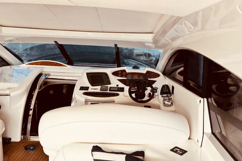 Slide: The Image of Interior view of 2003 Sunseeker Predator 61 yacht cockpit with modern controls and steering. - 14