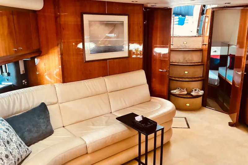 Slide: The Image of Luxurious interior of 2003 Sunseeker Predator 61 yacht with elegant wood paneling and plush seating. - 19