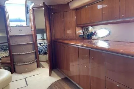 Slide: The Image of Luxurious interior of 2003 Sunseeker Predator 61 yacht with polished wood cabinetry. - 2