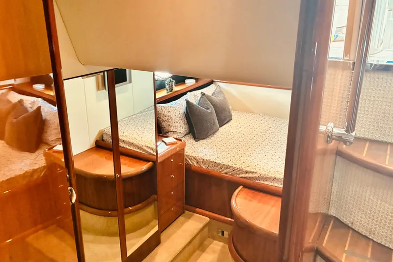 Slide: The Image of Luxurious cabin interior of a 2003 Sunseeker Predator 61 yacht, featuring elegant wood finishes. - 22