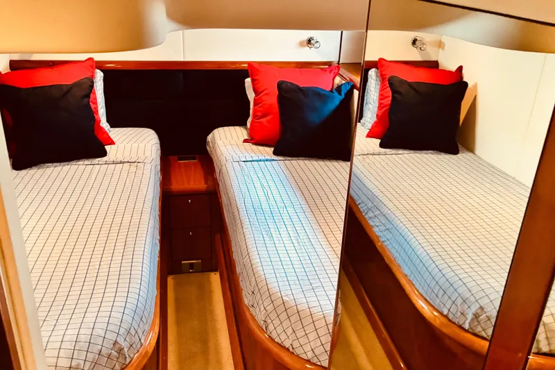 Slide: The Image of Luxurious twin cabin in 2003 Sunseeker Predator 61 yacht with stylish bedding and cushions. - 23