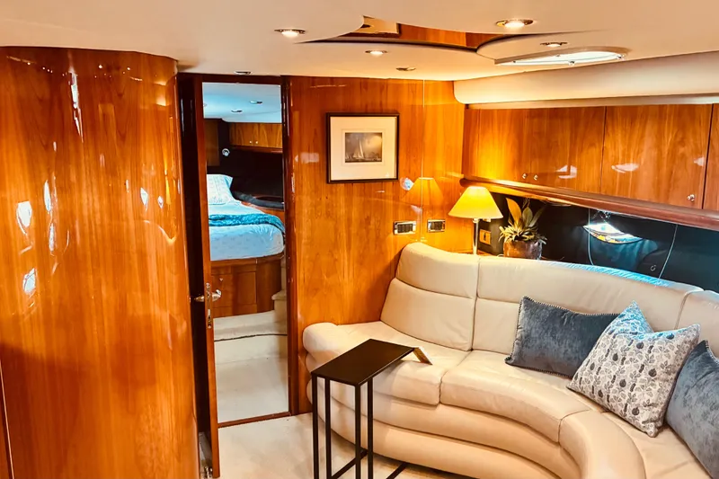 Slide: The Image of Luxurious interior of 2003 Sunseeker Predator 61 yacht with elegant wood paneling and plush seating. - 24