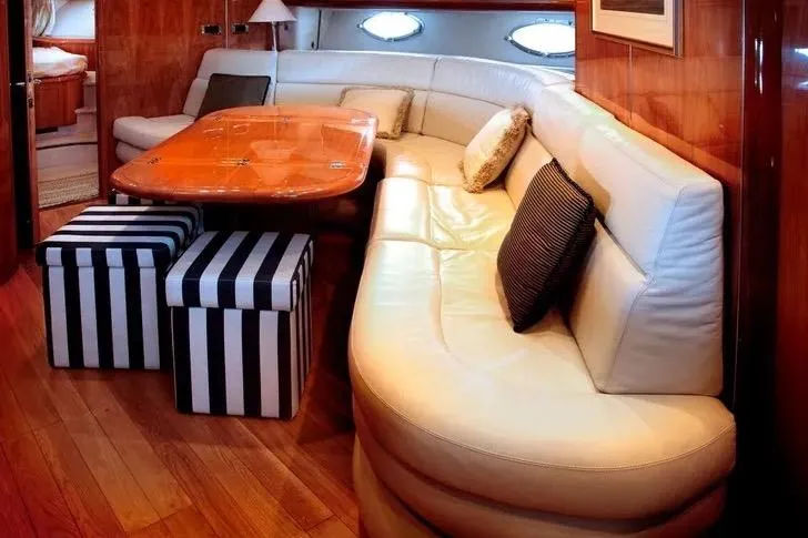 Slide: The Image of Luxurious interior of 2003 Sunseeker Predator 61 yacht with elegant seating and striped stools. - 4