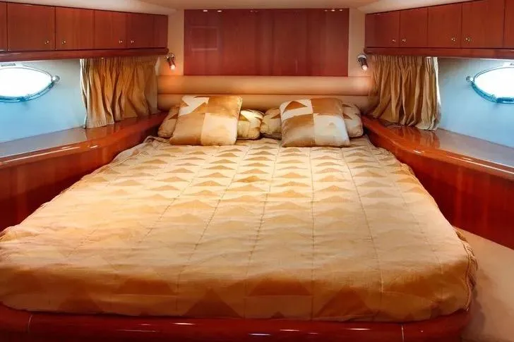 Slide: The Image of Luxurious bedroom interior of 2003 Sunseeker Predator 61 yacht with elegant wood finish. - 5