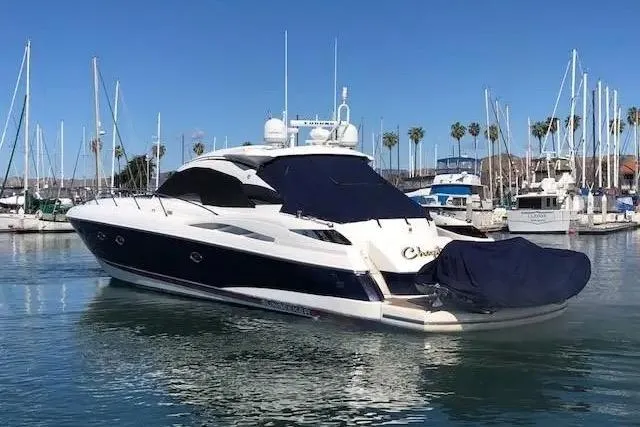 Slide: The Image of 2003 Sunseeker Predator 61 yacht docked in a marina under clear blue skies. - 6