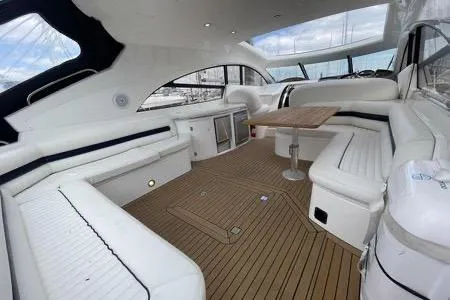 Slide: The Image of Luxurious 2003 Sunseeker Predator 61 yacht interior with white seating and wooden flooring. - 9