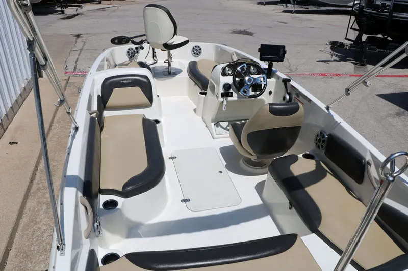 Slide: The Image of Interior view of a 2018 Stingray 182 SC boat with seating and helm. - 16
