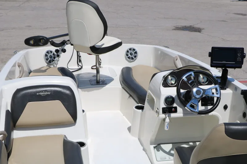 Slide: The Image of Interior of a 2018 Stingray 182 SC boat with steering console. - 17