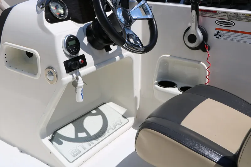 Slide: The Image of Interior of a 2018 Stingray 182 SC boat with steering console. - 38