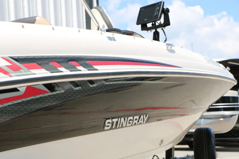 Slide: The Image of 2018 Stingray 182 SC boat with modern graphics and electronics. - 7