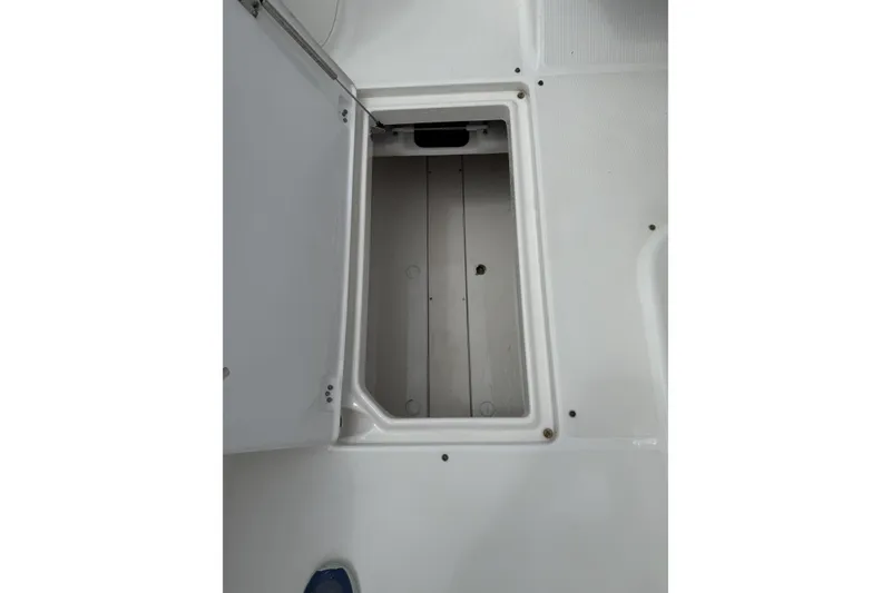 Slide: The Image of Open storage compartment on 2010 Robalo R227 Dual Console boat. - 11