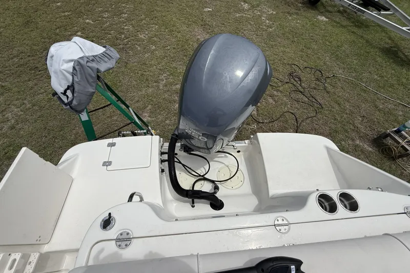 Slide: The Image of 2010 Robalo R227 Dual Console boat with outboard motor on grassy surface. - 12