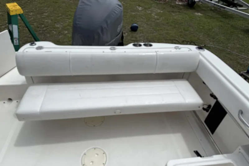 Slide: The Image of 2010 Robalo R227 Dual Console boat with white seating and cup holders. - 8