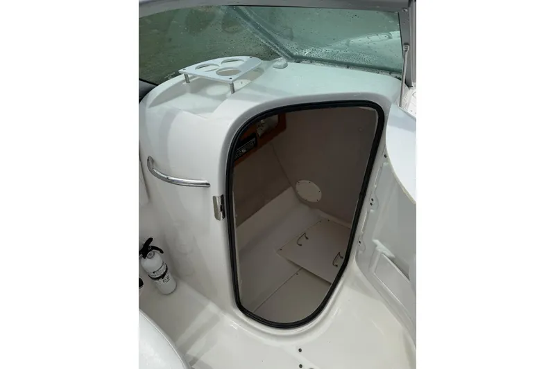Slide: The Image of 2010 Robalo R227 Dual Console boat interior with storage compartment and fire extinguisher. - 9