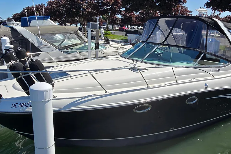 The Image of 2009 Chaparral Signature 310 boat docked at marina, featuring sleek design and modern amenities. - 0