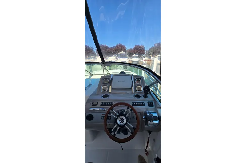 Slide: The Image of 2009 Chaparral Signature 310 boat helm with steering wheel and navigation equipment. - 11