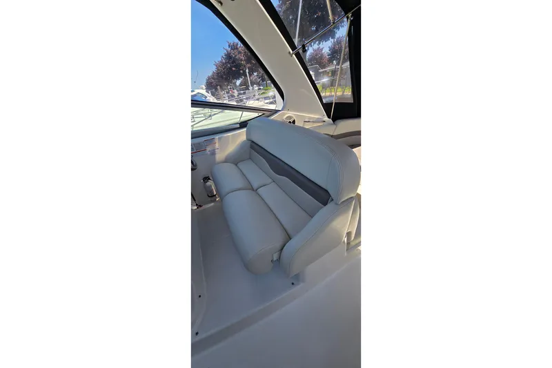 Slide: The Image of 2009 Chaparral Signature 310 boat interior with plush seating and window view. - 14
