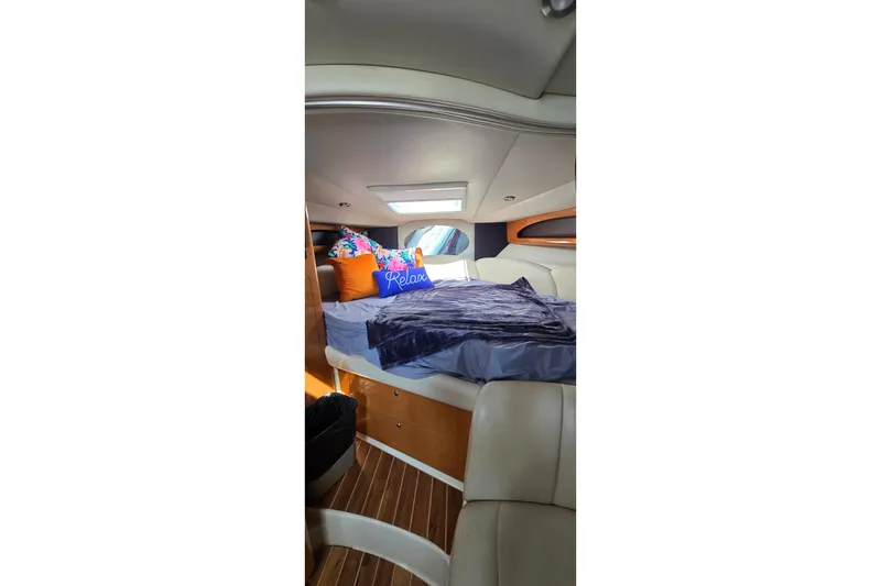 Slide: The Image of Interior of 2009 Chaparral Signature 310 yacht with cozy bed and colorful pillows. - 19