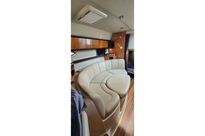 Slide: The Image of Luxurious interior of 2009 Chaparral Signature 310 yacht with plush seating and wood accents. - 20