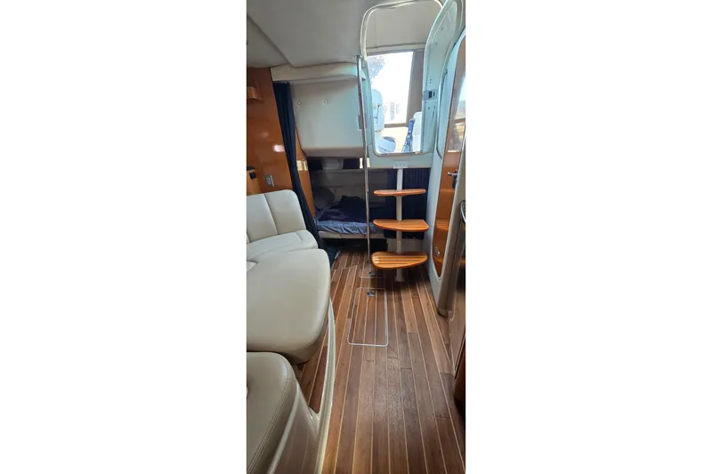 Slide: The Image of Interior of 2009 Chaparral Signature 310 yacht with wooden flooring and seating area. - 21