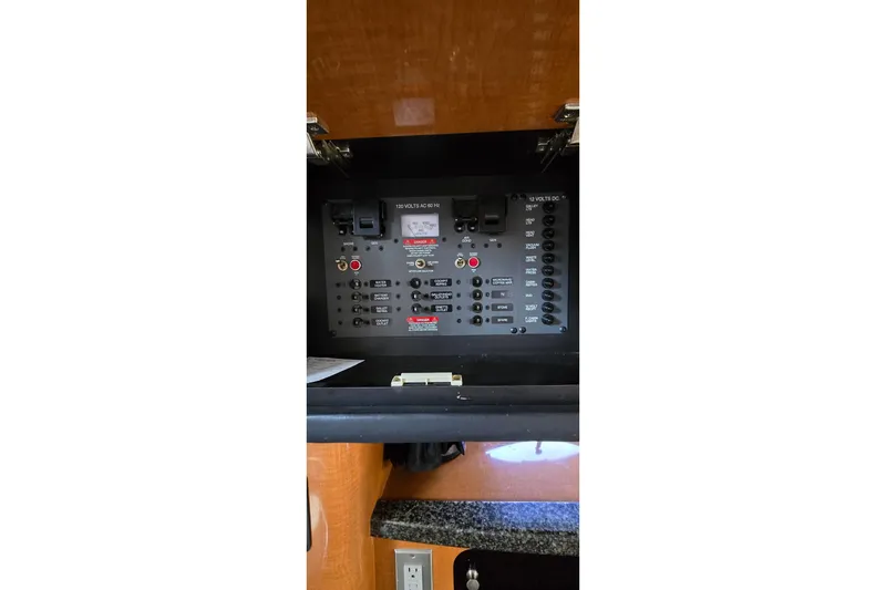 Slide: The Image of Electrical panel inside a 2009 Chaparral Signature 310 boat cabin. - 24