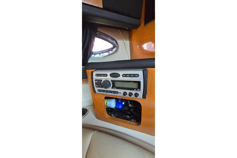 Slide: The Image of 2009 Chaparral Signature 310 cabin interior with stereo system and storage compartment. - 26