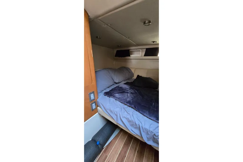 Slide: The Image of 2009 Chaparral Signature 310 cabin interior with cozy bed and wooden flooring. - 27