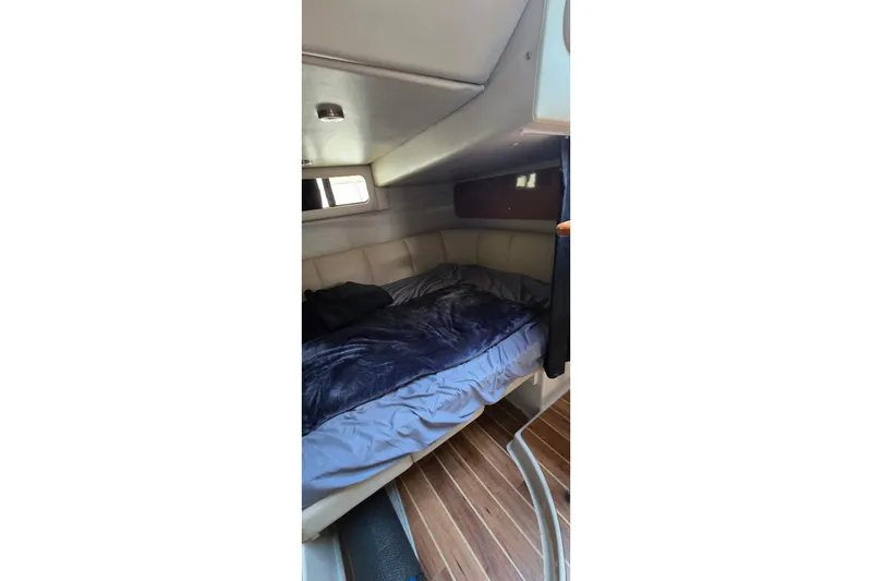 Slide: The Image of 2009 Chaparral Signature 310 cabin interior with cozy bed and wooden flooring. - 28