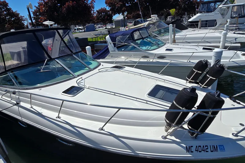 Slide: The Image of 2009 Chaparral Signature 310 boat docked in marina, surrounded by other vessels. - 3