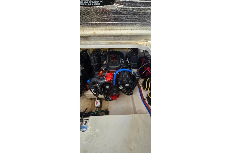 Slide: The Image of Engine compartment of a 2009 Chaparral Signature 310 boat, showcasing mechanical components. - 30