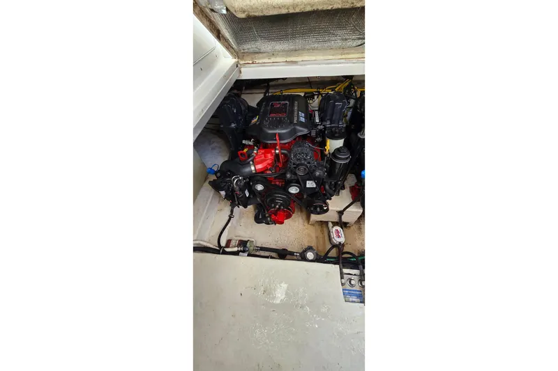 Slide: The Image of Engine compartment of a 2009 Chaparral Signature 310 boat, showcasing mechanical components. - 31