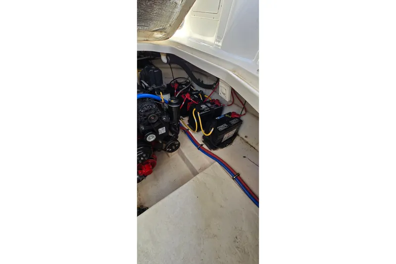 Slide: The Image of Engine compartment of 2009 Chaparral Signature 310 boat, showing batteries and wiring. - 32
