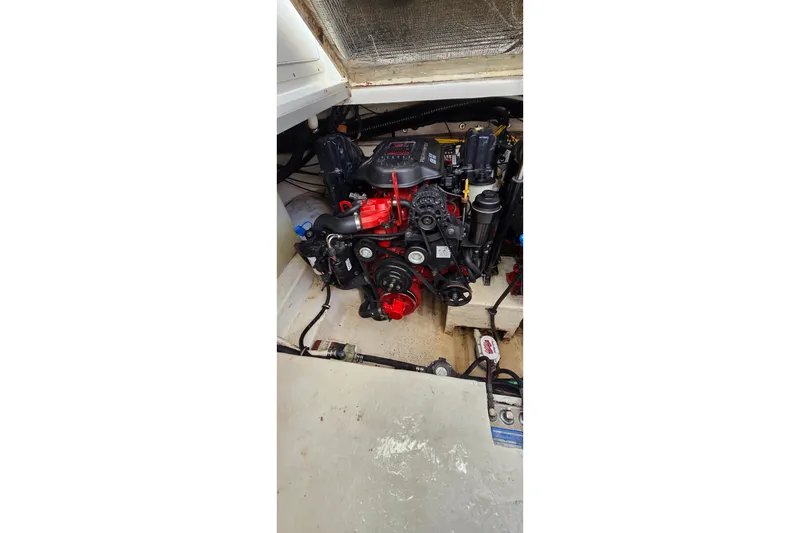 Slide: The Image of Engine compartment of a 2009 Chaparral Signature 310 boat, showcasing detailed mechanics. - 34