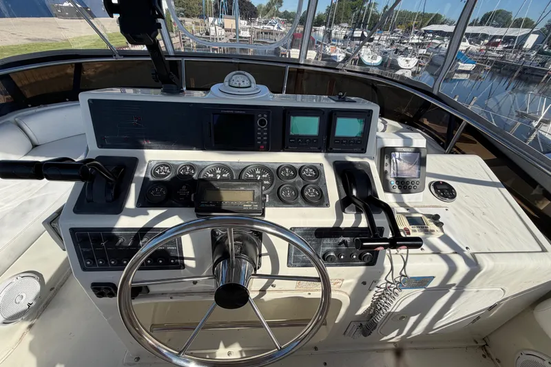 Slide: The Image of Cockpit of 1995 Silverton 37 Convertible yacht with steering wheel and navigation instruments. - 15