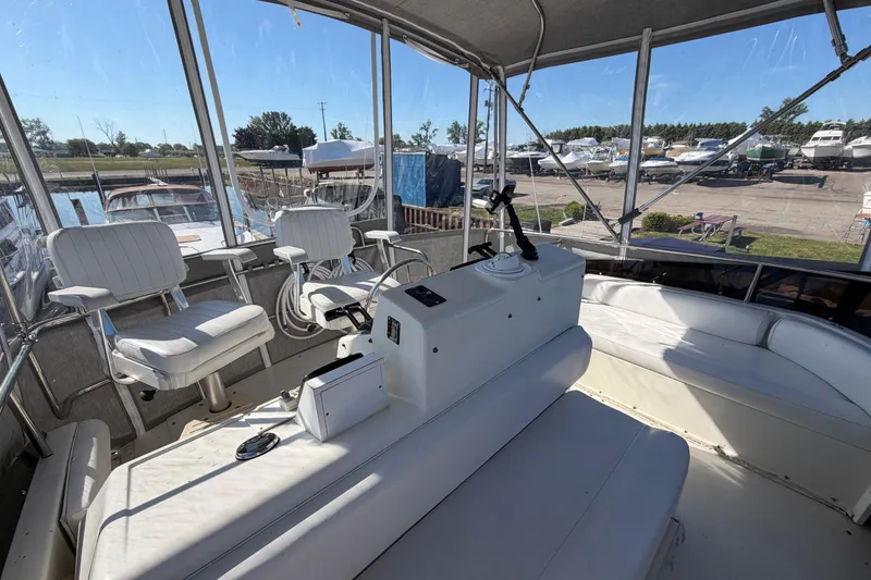 Slide: The Image of 1995 Silverton 37 Convertible boat interior with seating and helm, docked at marina. - 18