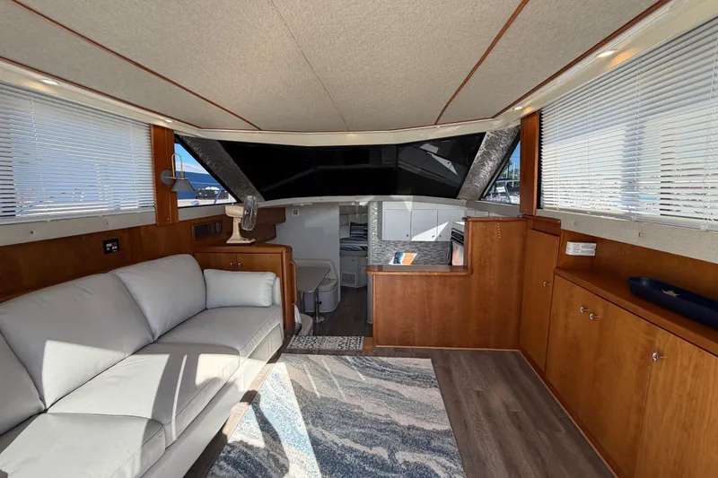 Slide: The Image of Interior of a 1995 Silverton 37 Convertible yacht with modern furnishings and ample natural light. - 19