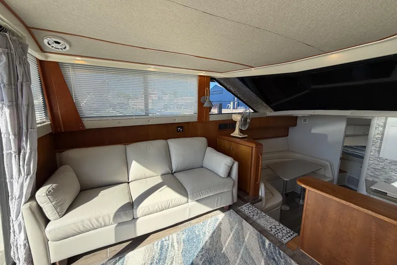 Slide: The Image of Interior of 1995 Silverton 37 Convertible yacht with sofa and dining area. - 20