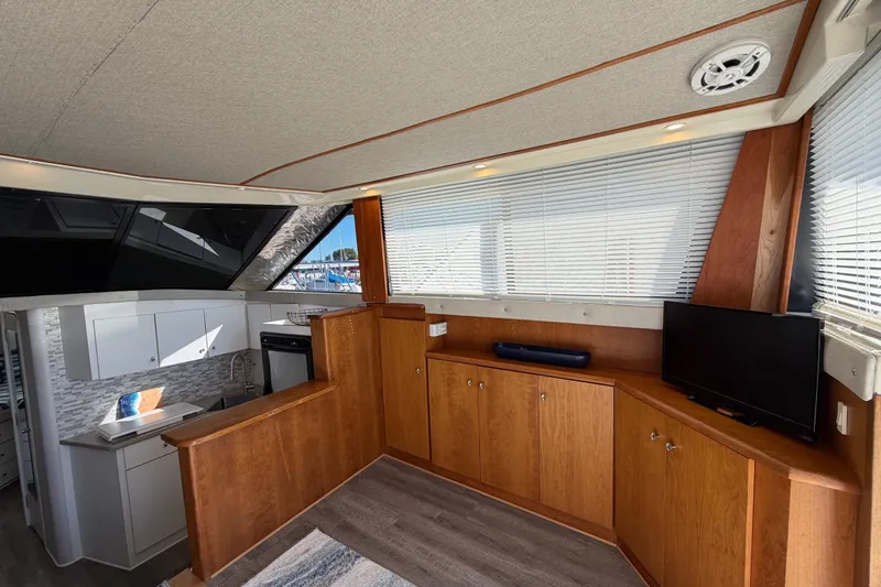 Slide: The Image of Interior of 1995 Silverton 37 Convertible yacht with wood cabinetry and modern amenities. - 21