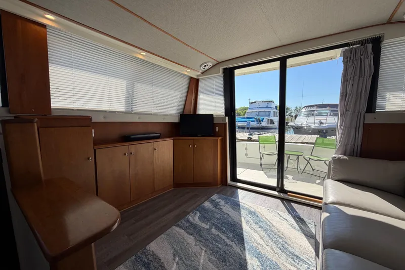 Slide: The Image of Interior of a 1995 Silverton 37 Convertible yacht with wood cabinets and marina view. - 22
