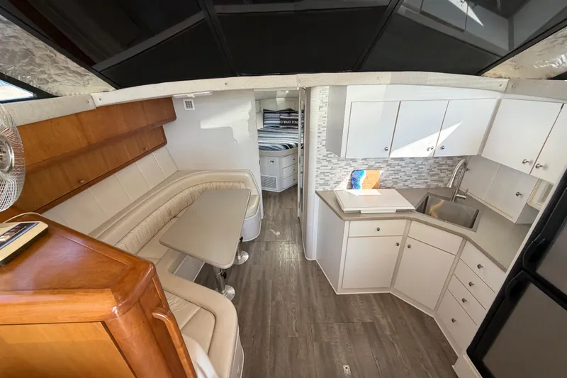Slide: The Image of Interior of a 1995 Silverton 37 Convertible yacht with modern kitchen and seating area. - 23