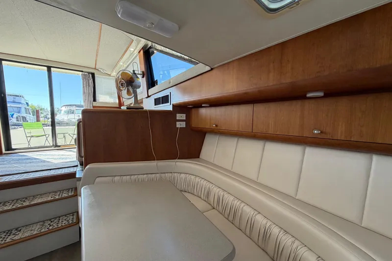 Slide: The Image of Interior of a 1995 Silverton 37 Convertible yacht with wood cabinetry and white seating. - 29