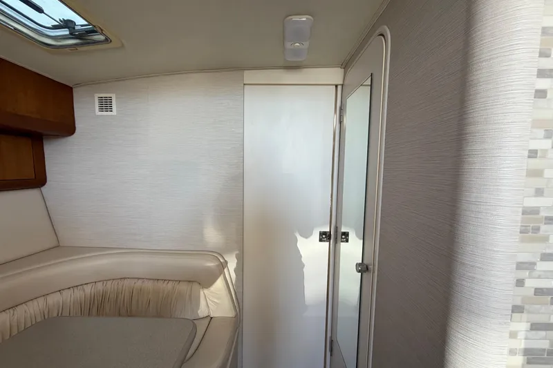 Slide: The Image of Interior of 1995 Silverton 37 Convertible yacht, featuring a cozy seating area and modern decor. - 31