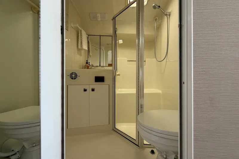 Slide: The Image of Bathroom interior of a 1995 Silverton 37 Convertible yacht, featuring shower and toilet. - 33