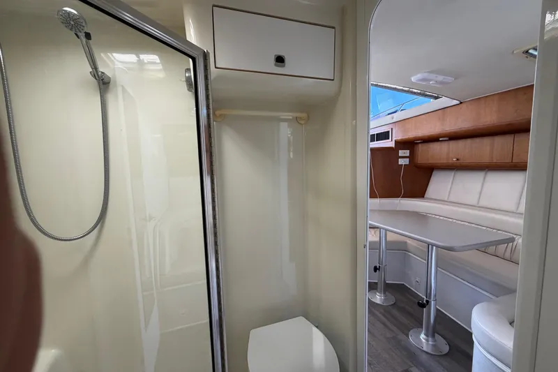 Slide: The Image of Interior of 1995 Silverton 37 Convertible yacht with shower and dining area. - 34