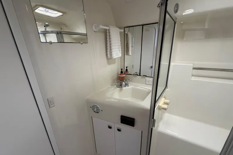 Slide: The Image of Bathroom interior of 1995 Silverton 37 Convertible yacht, featuring sink and shower. - 35