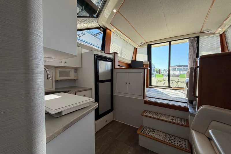 Slide: The Image of Interior of 1995 Silverton 37 Convertible yacht with kitchen and seating area. - 41