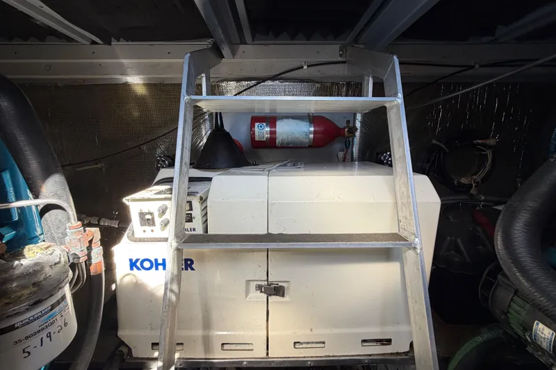 Slide: The Image of Engine room of 1995 Silverton 37 Convertible with Kohler generator and fire extinguisher. - 45