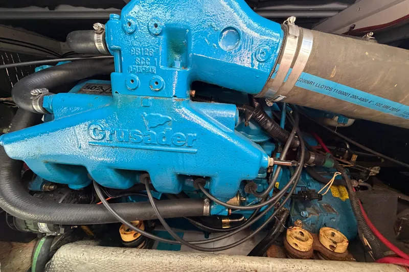 Slide: The Image of Engine of 1995 Silverton 37 Convertible boat, featuring blue Crusader components. - 47