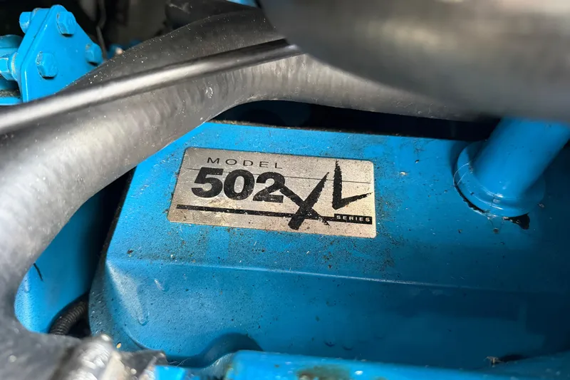 Slide: The Image of Close-up of a blue engine part labeled "Model 502 XL Series" from a 1995 Silverton 37 Convertible. - 49